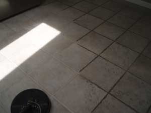 Picture showing clean tile next to uncleaned tile with dark grout lines