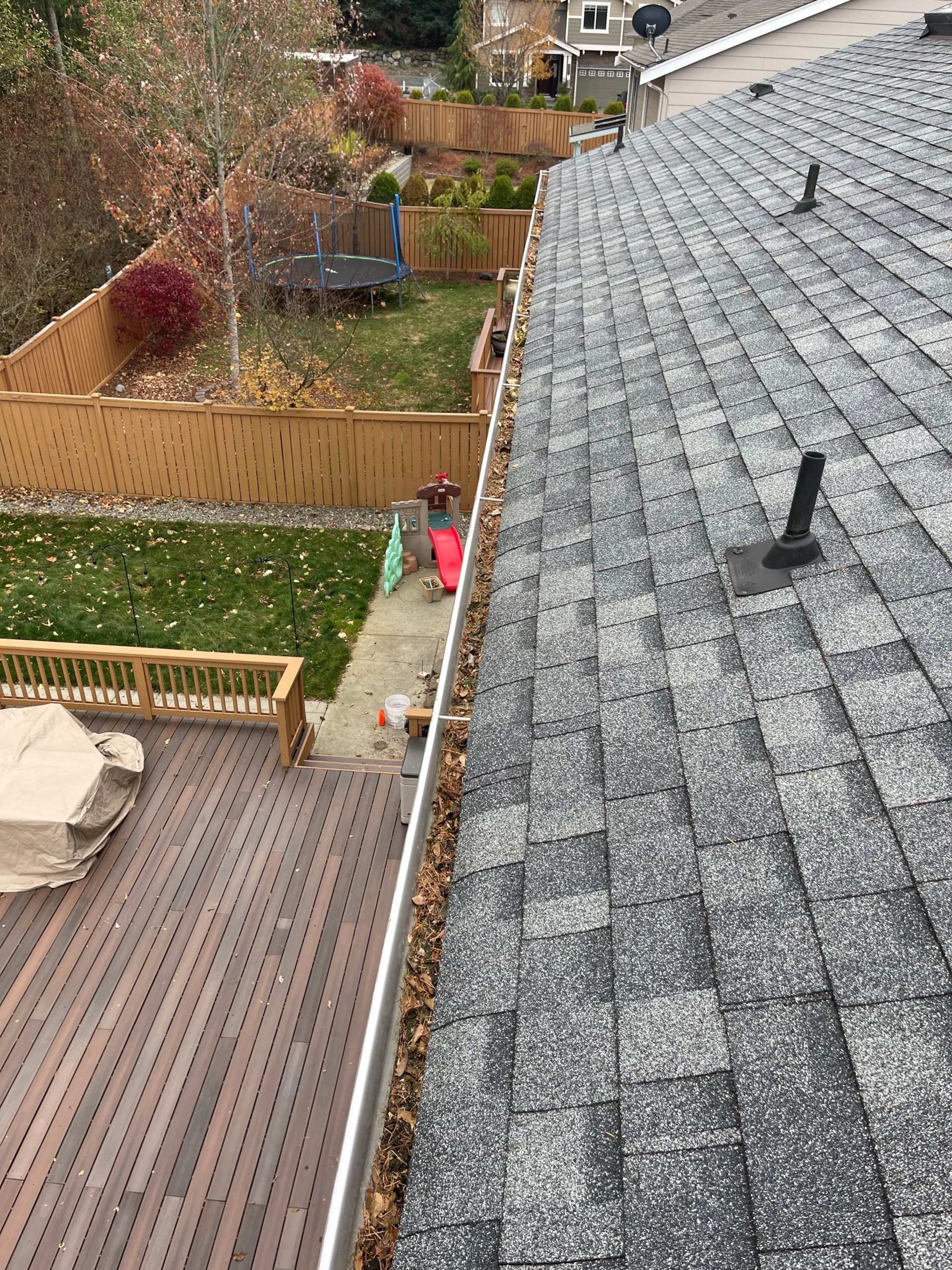 Picture showing gutters full of debris and leaves before gutter cleaning