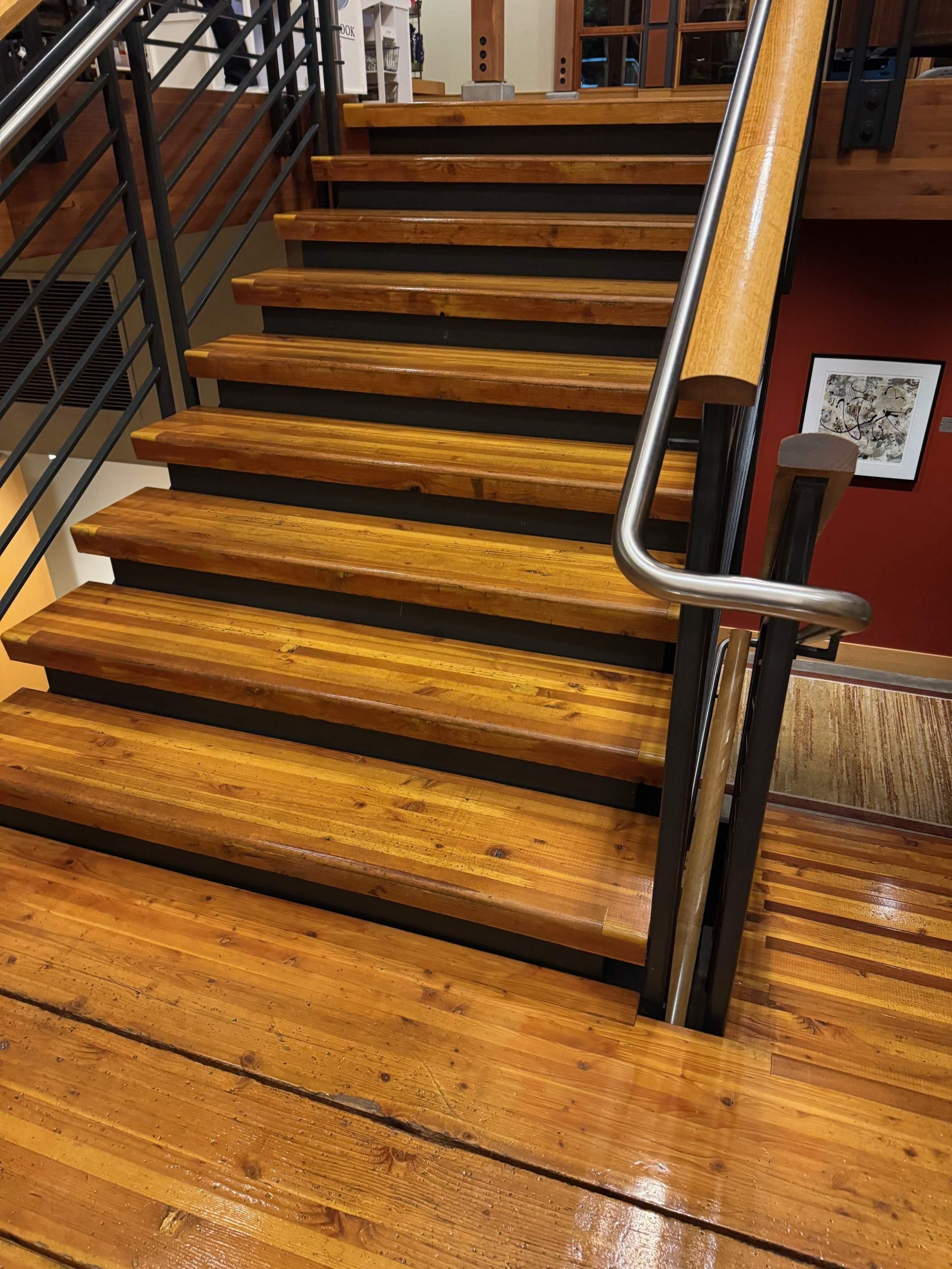 Restored wood staircase with glossy sealed treads and risers after professional hardwood cleaning service